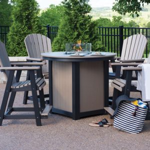 A round bar-height table with a fire pit in the middle surrounded by chairs.