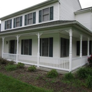 a white house with a wraparound porch