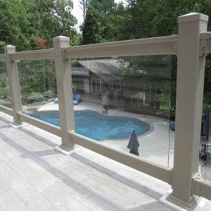 railing beside a deck overlooking a pool