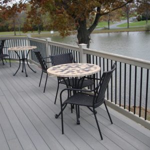 outdoor seating area beside a vinyl railing